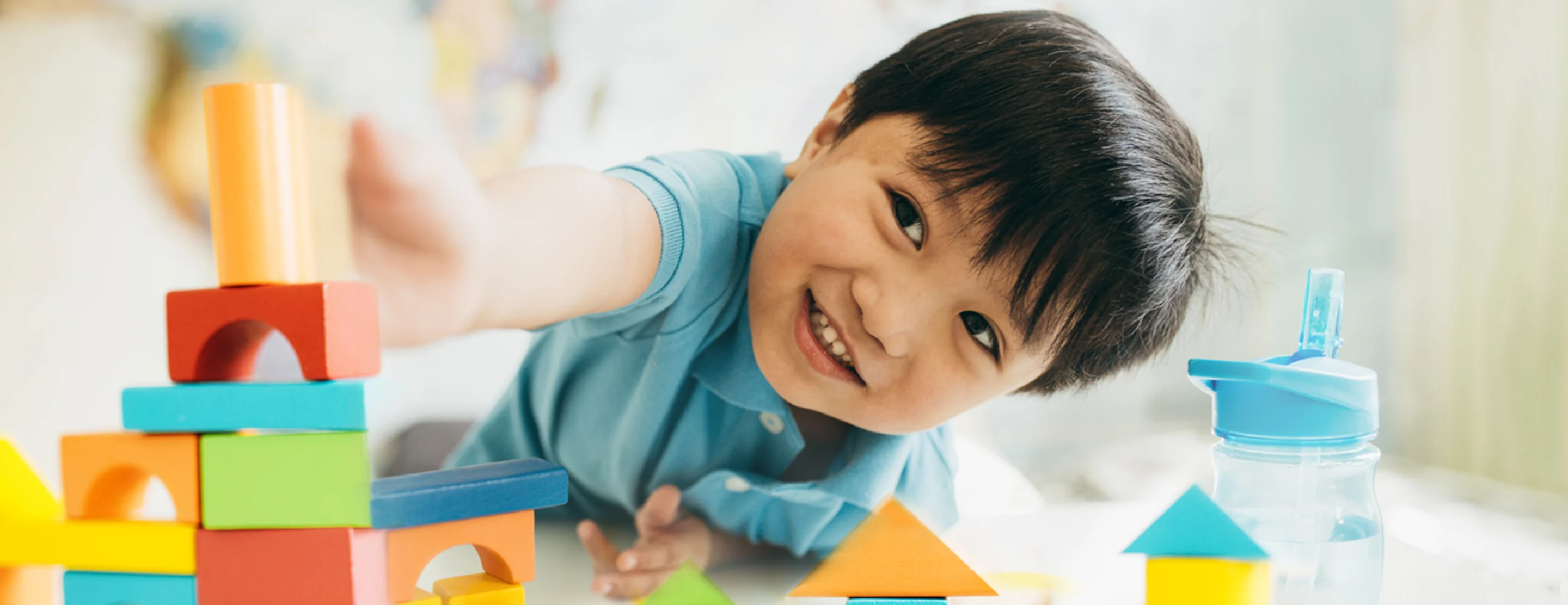 Child playing with colorful building blocks